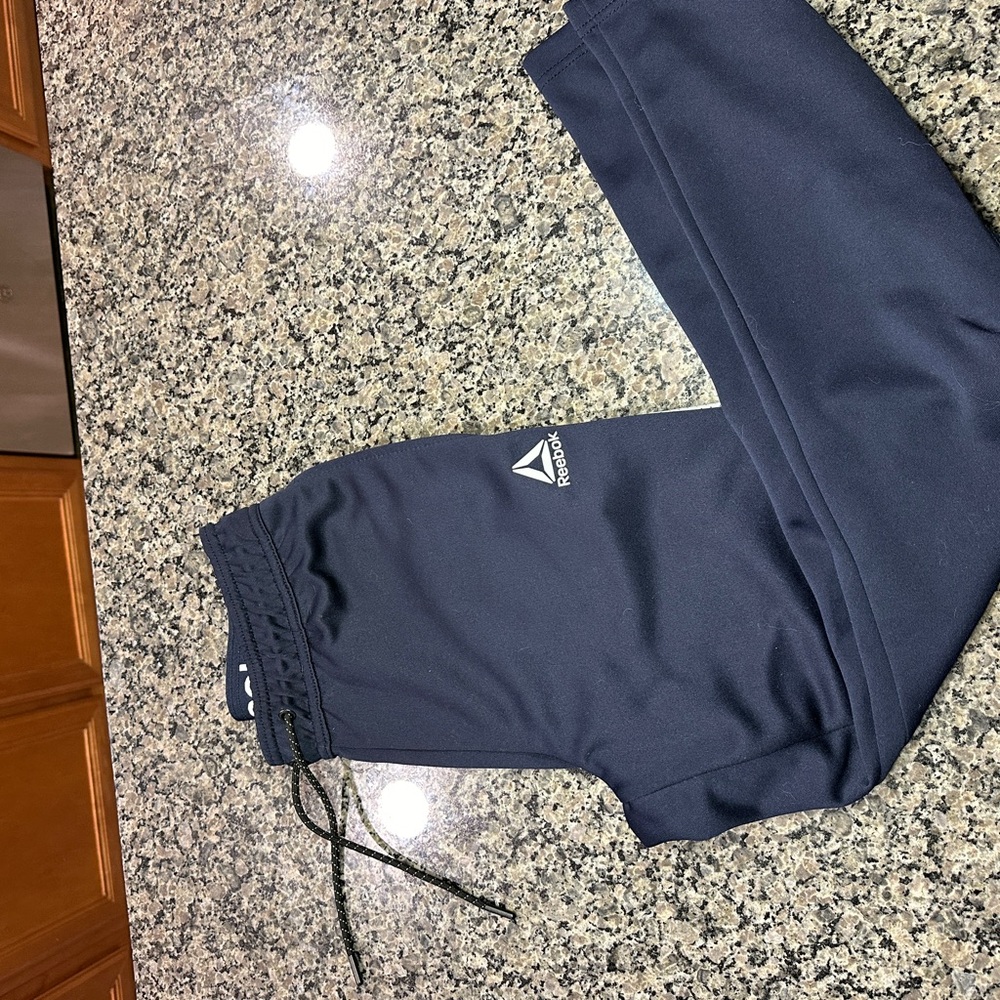 Dark blue reebook pants with zippers on legs size small